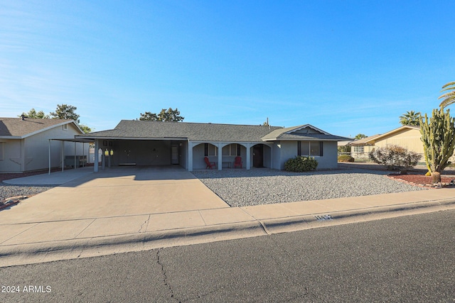 ranch-style home featuring a carport