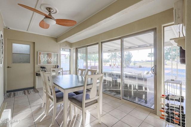 dining room with a wealth of natural light, ceiling fan, and light tile patterned flooring