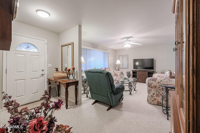 foyer entrance with light colored carpet and ceiling fan