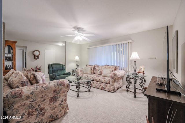 carpeted living room featuring ceiling fan