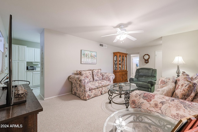 living room with carpet flooring and ceiling fan