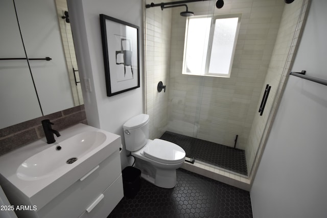 full bathroom featuring toilet, a shower stall, tile patterned flooring, and vanity