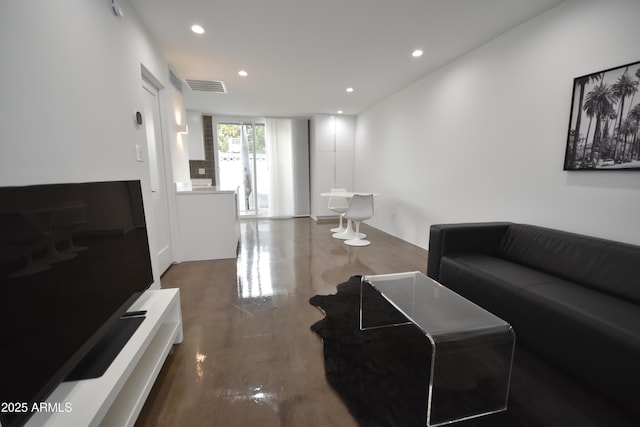 living area with recessed lighting and visible vents