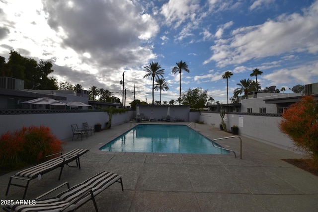 view of pool featuring a patio area, a fenced backyard, and a fenced in pool