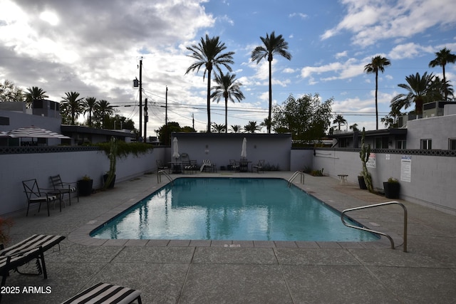 pool featuring a patio and fence