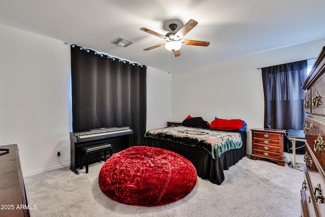 carpeted bedroom with baseboards, visible vents, and a ceiling fan