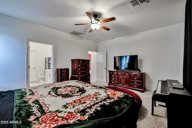 bedroom with a ceiling fan, carpet flooring, visible vents, and connected bathroom