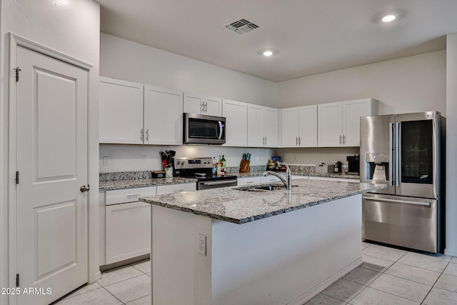 kitchen featuring light tile patterned floors, visible vents, appliances with stainless steel finishes, and a sink