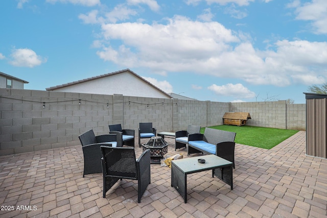 view of patio featuring an outdoor fire pit and a fenced backyard