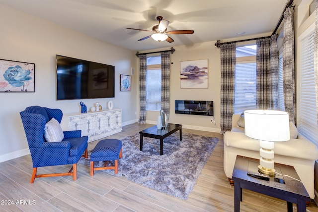 living room featuring ceiling fan and light hardwood / wood-style flooring