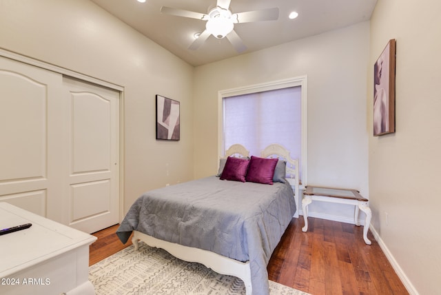 bedroom with dark wood-type flooring, a closet, and ceiling fan