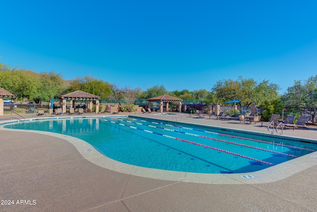 view of swimming pool featuring a gazebo and a patio area