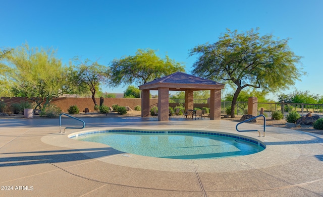 view of swimming pool featuring a patio and a gazebo