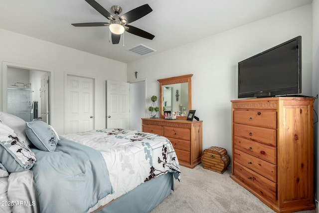 carpeted bedroom featuring ceiling fan and ensuite bathroom