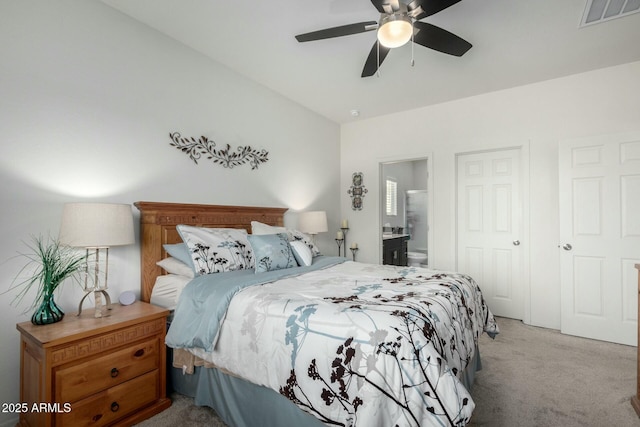 carpeted bedroom with ceiling fan and ensuite bathroom