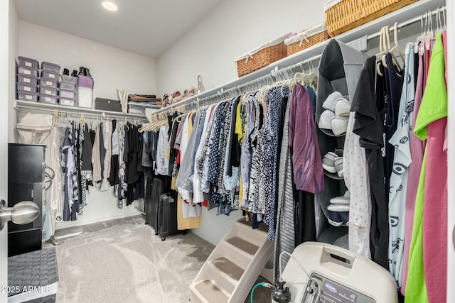 spacious closet with washer / clothes dryer and carpet flooring