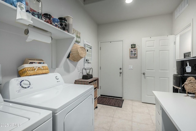 clothes washing area featuring washing machine and dryer and light tile patterned flooring