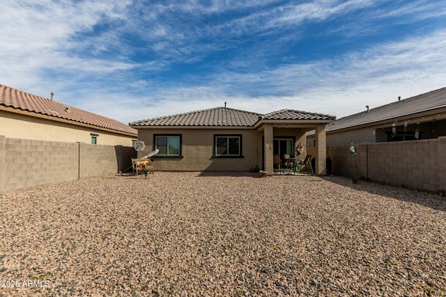 back of property with a patio