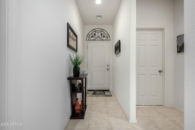 hall with light tile patterned floors