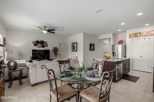 dining area with sink, ceiling fan, and light tile patterned flooring