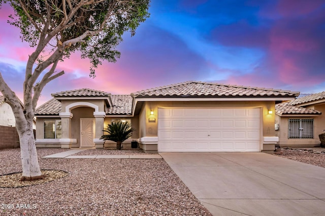 mediterranean / spanish-style home with a garage