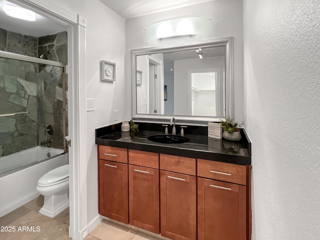 full bathroom with tile patterned floors, vanity, toilet, and combined bath / shower with glass door