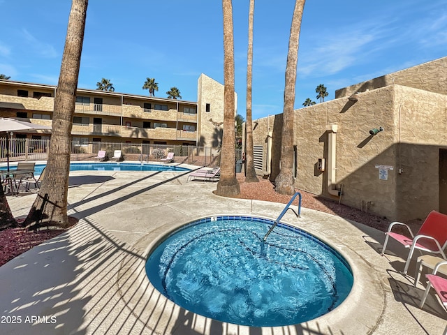 view of swimming pool featuring a community hot tub