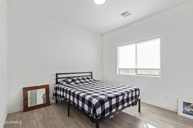 bedroom with light hardwood / wood-style floors