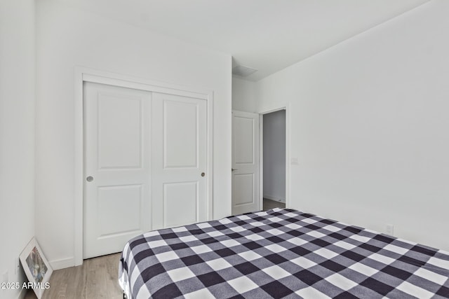 unfurnished bedroom featuring light hardwood / wood-style floors and a closet