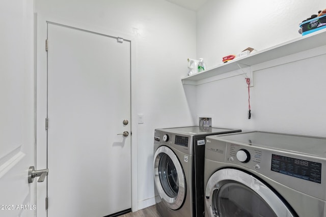 clothes washing area featuring independent washer and dryer