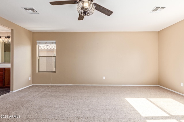 carpeted spare room with ceiling fan