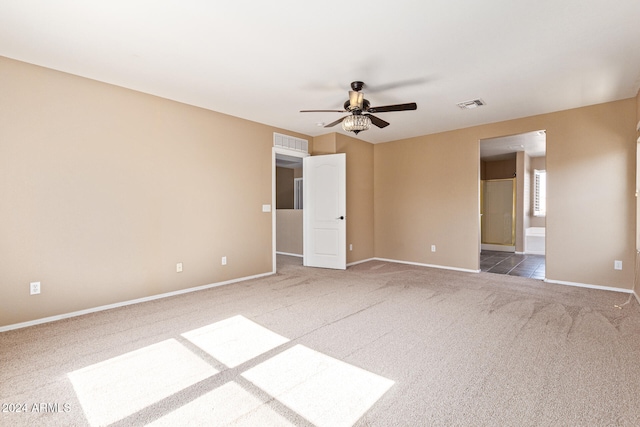 empty room featuring ceiling fan and carpet floors