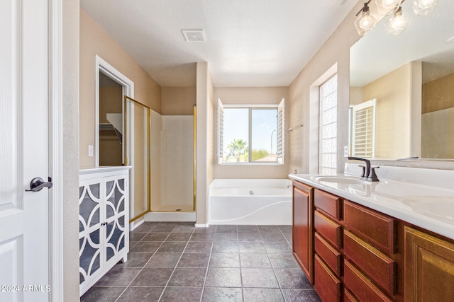 bathroom featuring vanity and independent shower and bath