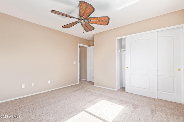 unfurnished bedroom featuring a closet, light carpet, and ceiling fan