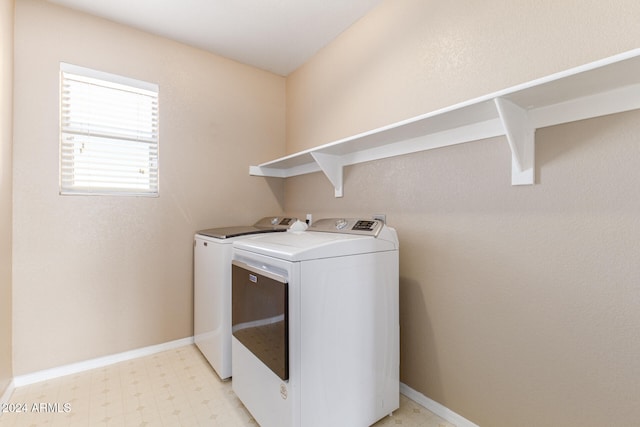 clothes washing area with washing machine and dryer