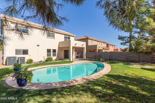 view of pool featuring central AC unit and a yard