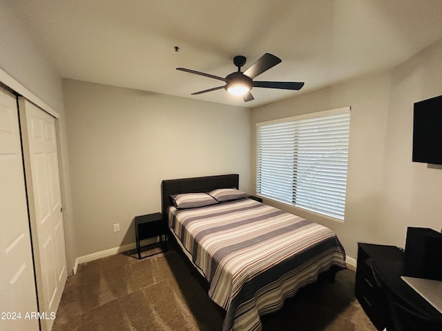 carpeted bedroom with ceiling fan and a closet