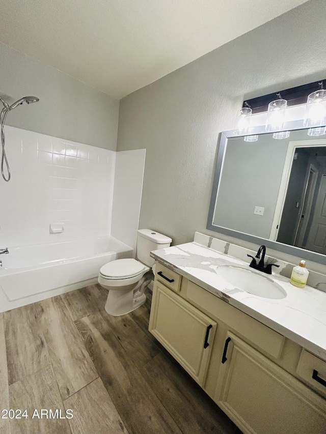 full bathroom featuring bathtub / shower combination, wood-type flooring, toilet, and vanity