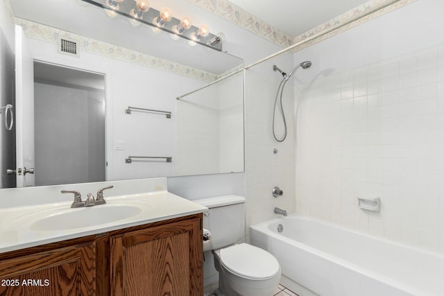 full bathroom with toilet, vanity, and tiled shower / bath