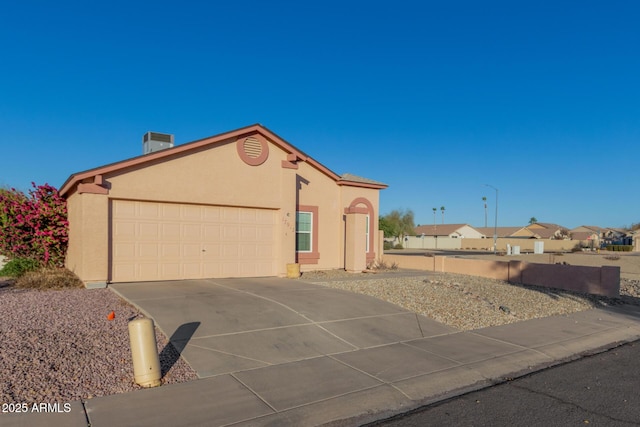 view of front of home featuring a garage and cooling unit