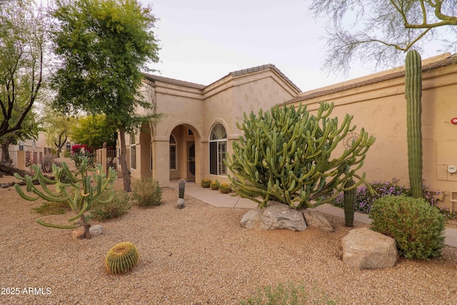 mediterranean / spanish-style house with a tile roof and stucco siding