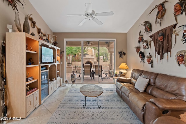 living area featuring light tile patterned floors, ceiling fan, and vaulted ceiling