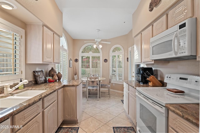 kitchen with light tile patterned floors, ceiling fan, white appliances, a sink, and baseboards