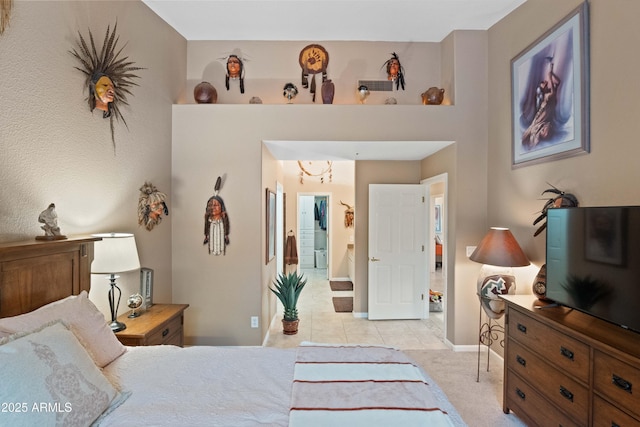 bedroom with baseboards and light tile patterned flooring