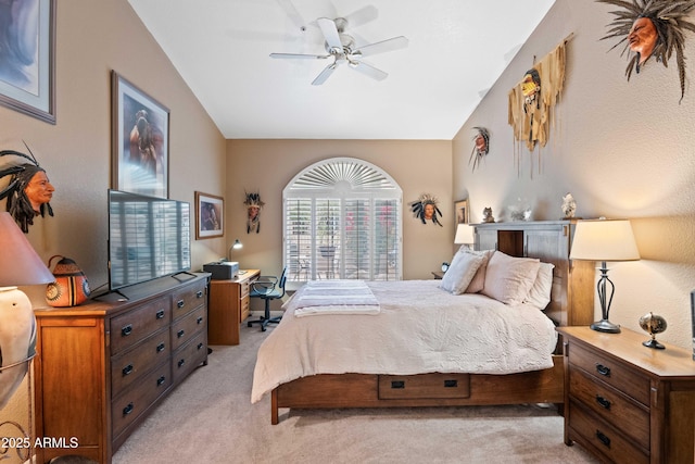 bedroom with a ceiling fan, light carpet, and vaulted ceiling