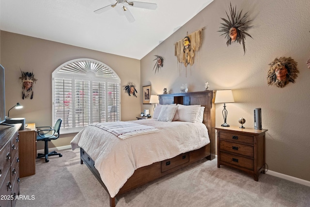 carpeted bedroom featuring a ceiling fan, lofted ceiling, and baseboards