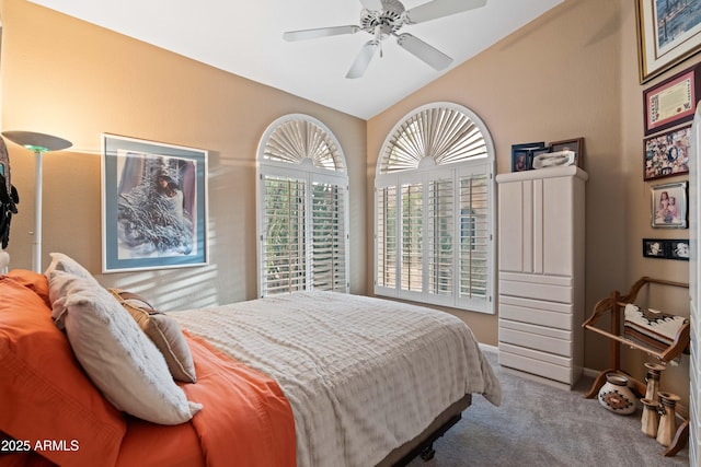 bedroom with lofted ceiling, carpet flooring, and a ceiling fan