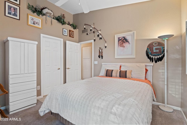 bedroom featuring carpet floors, visible vents, and baseboards