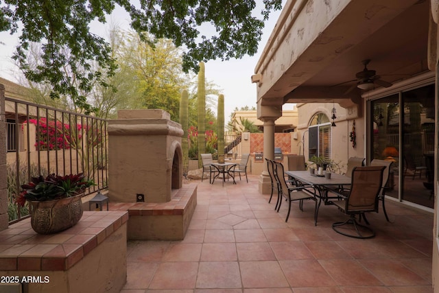 view of patio featuring ceiling fan, fence, and outdoor dining area