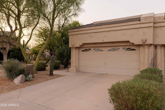 garage featuring concrete driveway